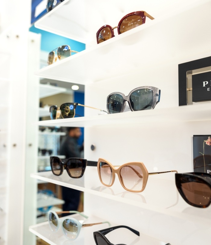 several pairs of glasses sitting on a shelf
